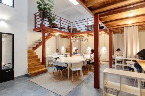 a group of people sitting at a table in a restaurant at Dear Lisbon - Gallery House in Lisbon
