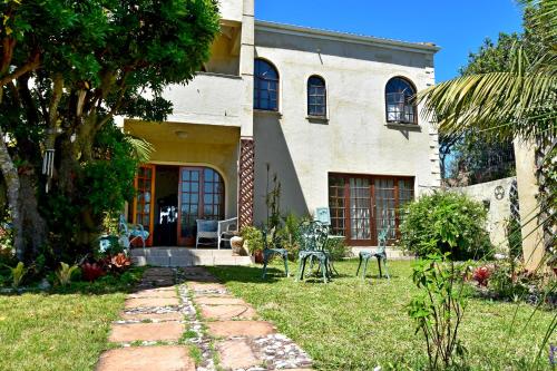 a house with a pathway leading to the front yard at Sea Valley Villa in Port Alfred