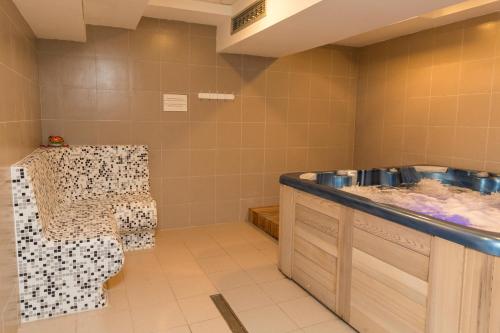 a bathroom with a counter and a table and a sink at Hotel Ana Lux Spa in Pirot