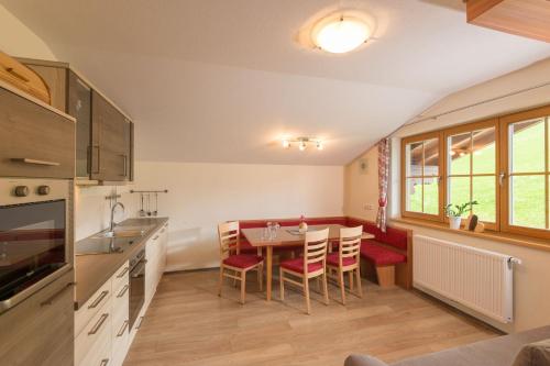 a kitchen and dining room with a table and chairs at Hinteregghof in Forstau
