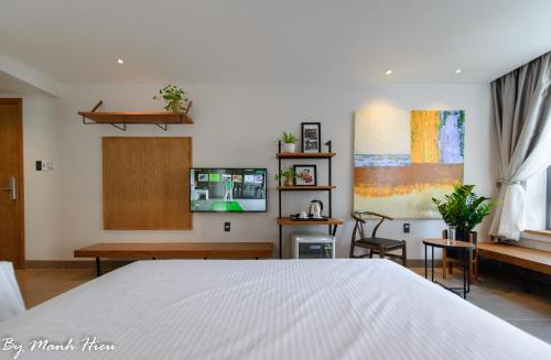 a bedroom with a bed and a living room at Mojzo Inn Boutique Hotel in Nha Trang