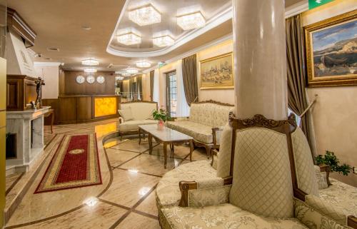 a living room with couches and a column in a building at Residence City Garden - Certificate of Excellence Top 10 BEST Five-Stars City Hotels for 2024 awarded by HTIF in Plovdiv