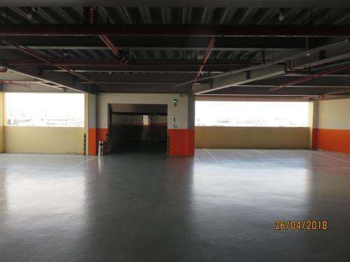 a large empty room with orange and white walls at Mao Hua Motel in Dajia