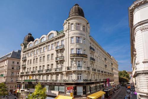 a large white building on a city street at Hotel Astoria Vienna, Curio Collection by Hilton in Vienna