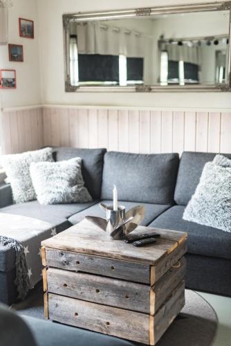 a living room with a couch and a wooden coffee table at Airisto Hill & Inn - Two Beach Cabins in Haverö