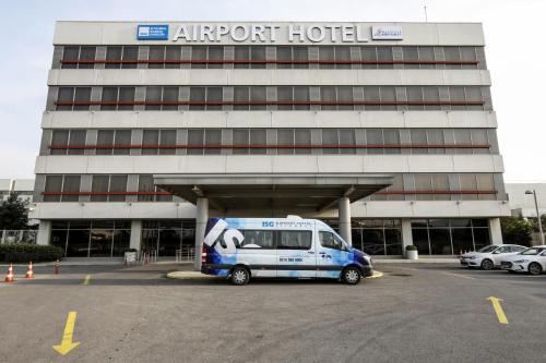 a van parked in a parking lot in front of an airport hotel at ISG Sabiha Gökçen Airport Hotel in Istanbul