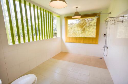 a bathroom with a toilet and a window at Cat Tien Jungle Lodge in Cat Tien