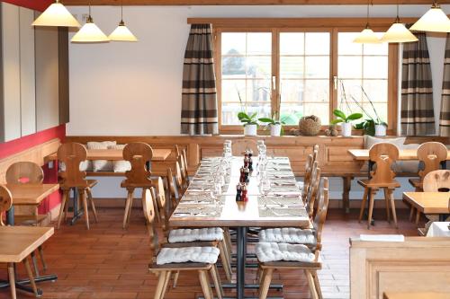 a dining room with wooden tables and chairs at Hotel Ucliva in Waltensburg