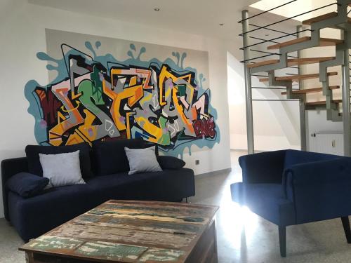 a living room with a painting on the wall at Münch 10 in Kaiserslautern