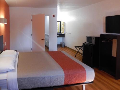 a hotel room with a bed and a television at Motel 6-Moultrie, GA in Moultrie