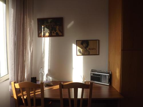 une table à manger avec des chaises et un four micro-ondes dans l'établissement Sa Sindria, à Cagliari