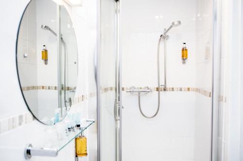 a bathroom with a shower and a mirror at The Lerryn in Falmouth