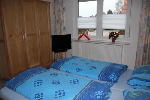Un pat sau paturi într-o cameră la Haus Swantje