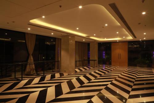 a lobby with a black and white checkered floor at The Vern at BLVD in Nashik