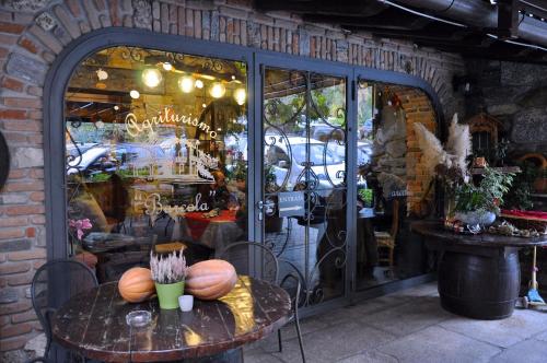 a table with pumpkins on it in front of a store at Agriturismo Barcola in Grandola ed Uniti