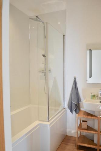 a bathroom with a shower and a sink at Millbank Cottage in Blairgowrie