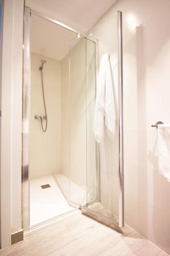 a shower with a glass door in a bathroom at Apartaments Es Port para largas estancias in Colònia de Sant Jordi