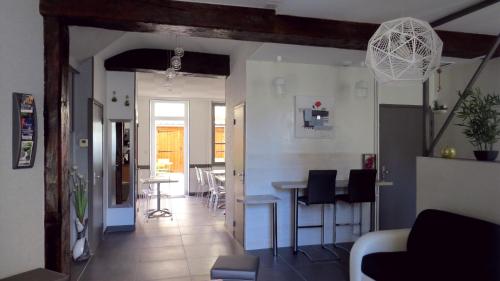 a kitchen and living room with a table and chairs at Hôtel de Clèves in Nevers