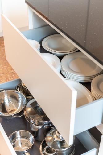 a drawer filled with plates and pans in a kitchen at Palazzo Vendramin Costa in Venice