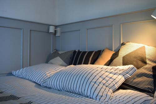 a bed with a headboard and pillows on it at Gellért Hill Apartment in Budapest