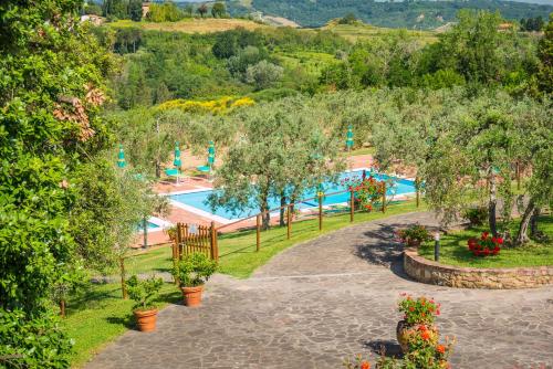 a resort with a swimming pool in a park at Borgo Di Collelungo in Montaione