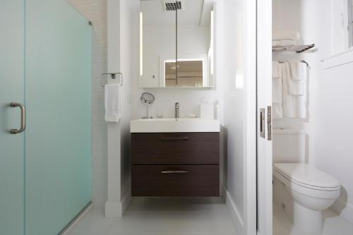 a bathroom with a sink and a toilet at Station Inn Pawling in Pawling