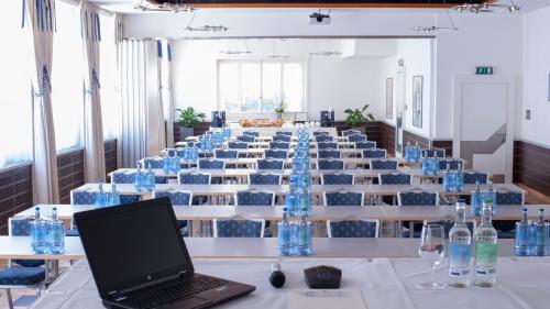 a room filled with tables and chairs filled with laptops at Hotel Krone Unterstrass in Zürich