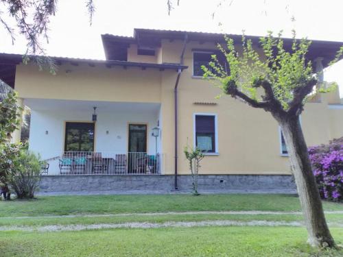 una casa con un árbol delante de ella en Il Guscio, en Baveno