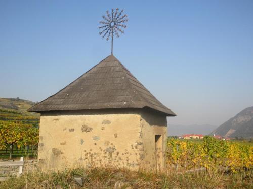 an old building with a windmill on top of it at GästeHaus Rudolf u. Sandra DENK in Wösendorf
