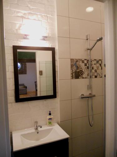 a bathroom with a sink and a mirror at Apartament Katowice - Nikiszowiec in Katowice