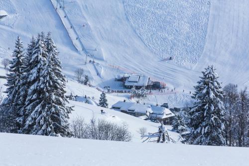 a ski resort with a ski lift in the snow at Forsters Schwarzwald Hof - Resort-Hotel&Pension in Feldberg