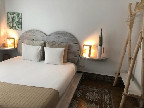 a bedroom with a white bed with two pillows at Cactus Host in Las Palmas de Gran Canaria