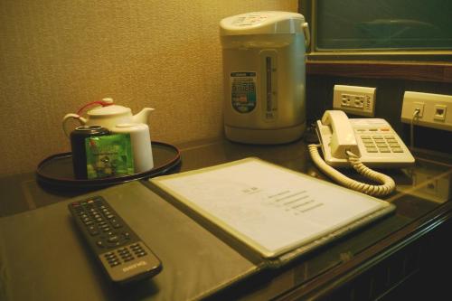 a desk with a phone and a phone at Shan-Yue Hotspring Hotel in Taipei