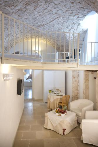 a living room with a bunk bed and two tables at Hotel Corte Altavilla in Conversano