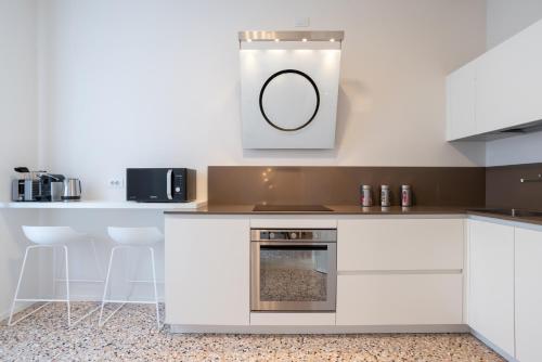 a kitchen with white cabinets and an oven at Palazzo Vendramin Costa in Venice