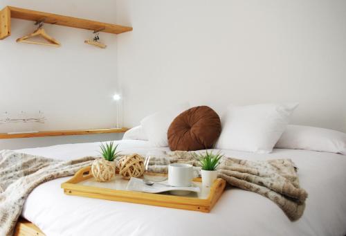 a bed with a tray with a basketball on it at Can Girmas Casa de Turisme rural Navata in Navata