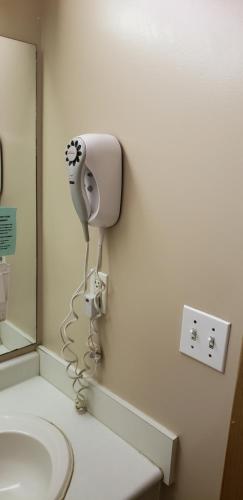 a bathroom with a hair dryer on the wall at Travel-Inn Resort & Campground in Saskatoon