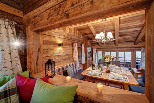 a dining room with wooden walls and a wooden table at Highking Chalet Grünegg in Dienten am Hochkönig