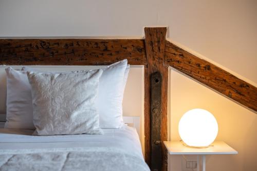 a bed with a wooden headboard and a lamp on a table at Palazzo Vendramin Costa in Venice