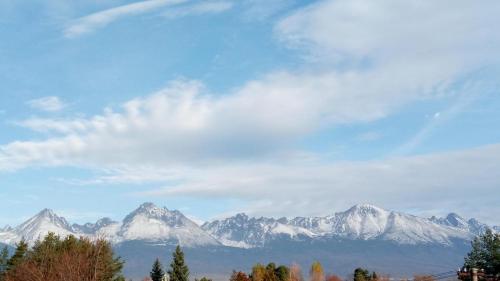 a view of snow capped mountains under a cloudy sky at Svit Dovolenkový dom in Svit