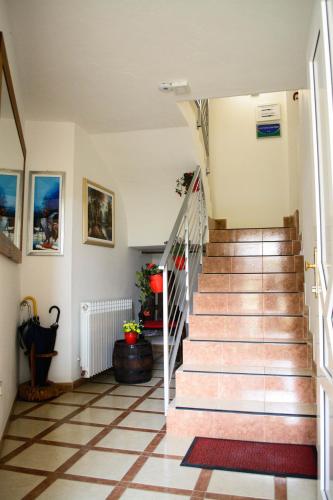 a staircase in a house with a tile floor at Apartmani Janjic in Banja Luka