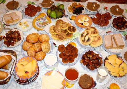 a table topped with lots of different types of food at Auberge Restaurant Rooftop Tamazirt in Boumalne