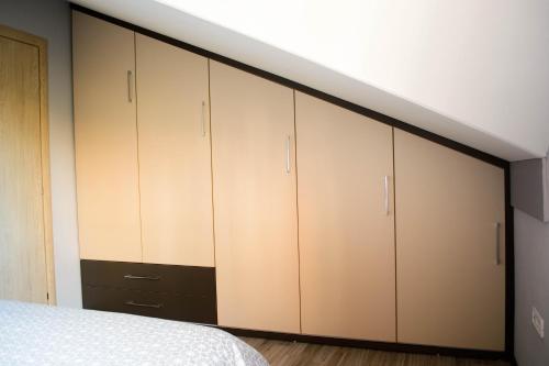a bedroom with white cabinets and a bed at Apartmani Janjic in Banja Luka