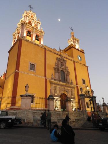 a large yellow building with a clock tower at Casa del Temezcuitate in Guanajuato