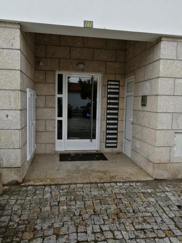 an entrance to a house with a door and a patio at Congidouro in Freixo de Espada à Cinta
