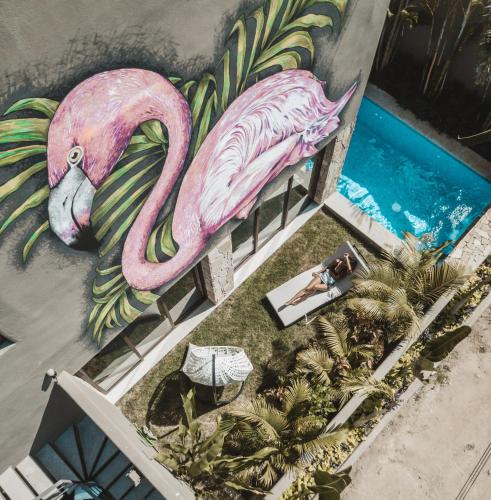 a painting of a pink flamingo next to a pool at Villa Vargas Sayulita in Sayulita
