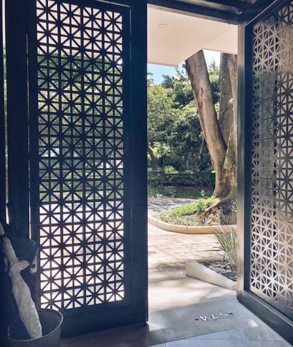 an open door to a courtyard with a tree at 574 Hotel in Medellín