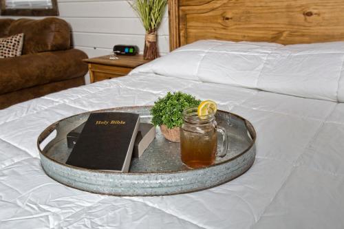 a tray with a book and a jar of honey on a bed at Stateline Cabin in Hobbs