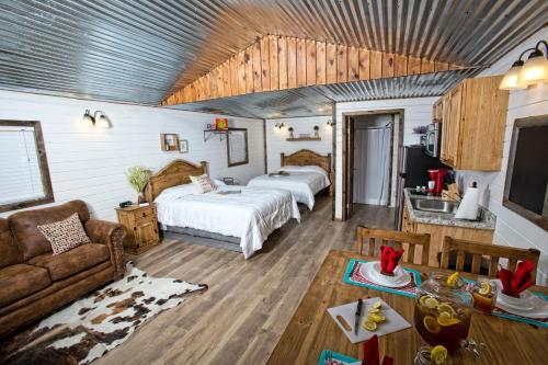 a bedroom with two beds and a living room with a couch at Stateline Cabin in Hobbs