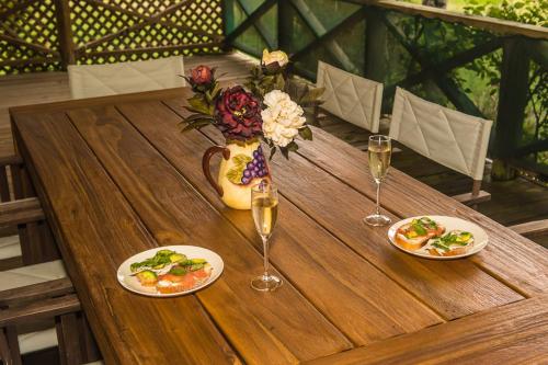 a wooden table with plates of food and glasses of wine at Silverpoint Estate in Pokolbin